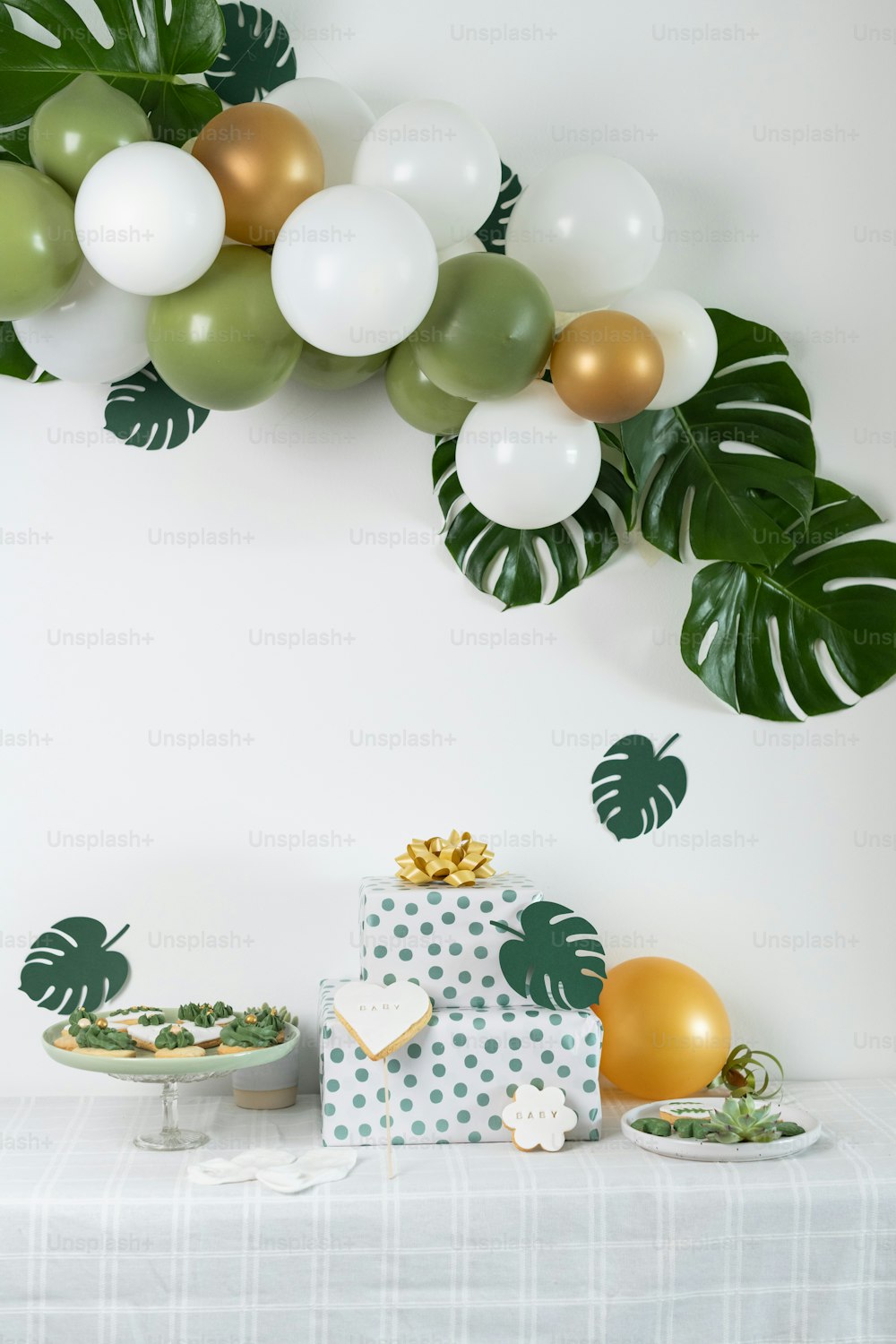 a table topped with a cake covered in white frosting