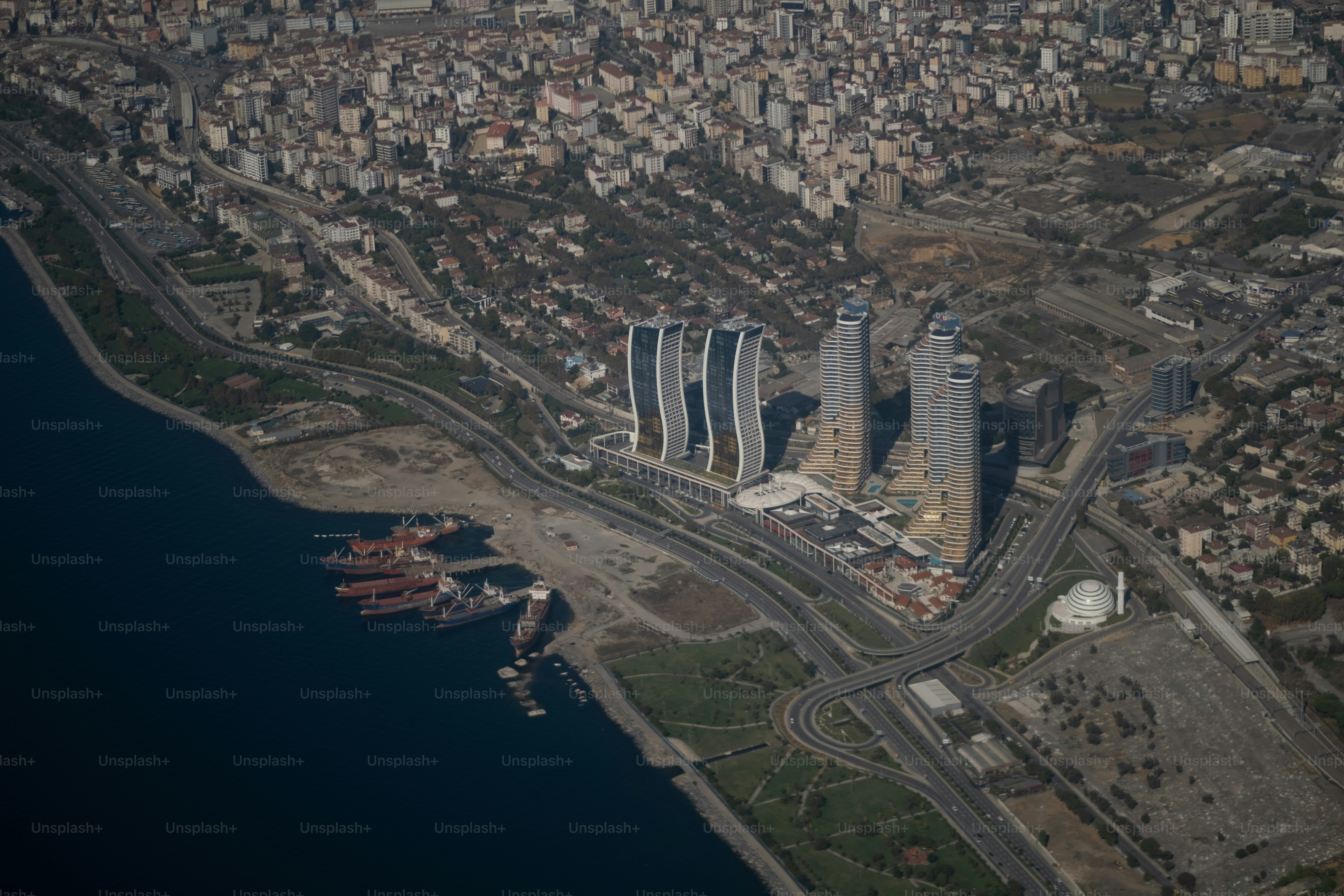 Commercial ships pull into Istanbul, where new construction towers over the shoreline.