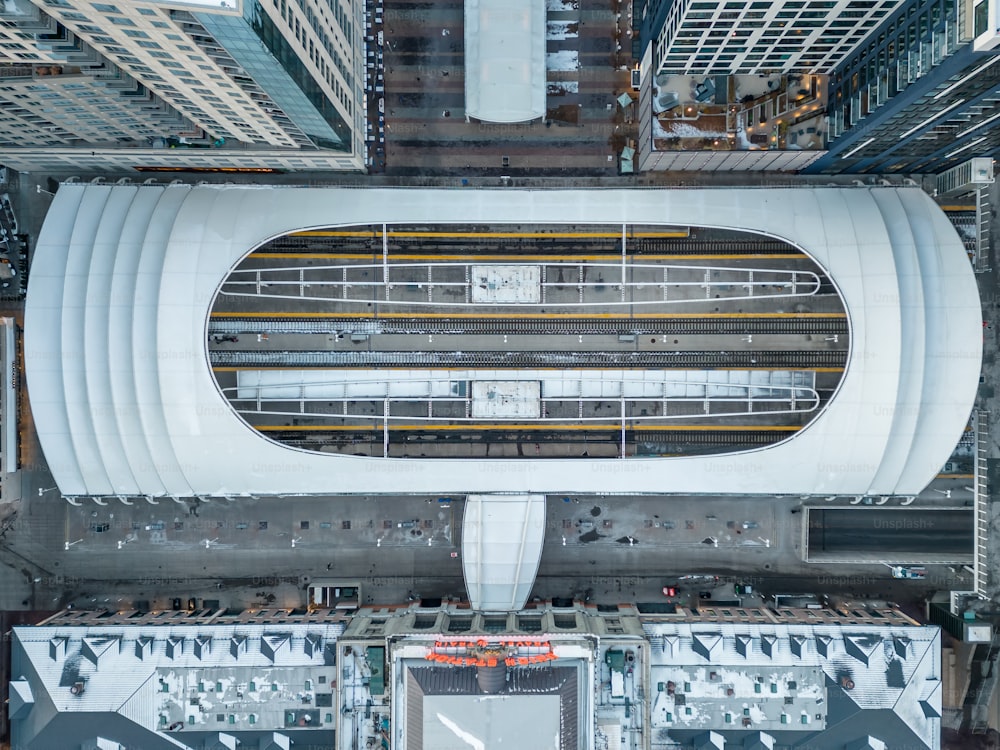 an aerial view of a train station in a city