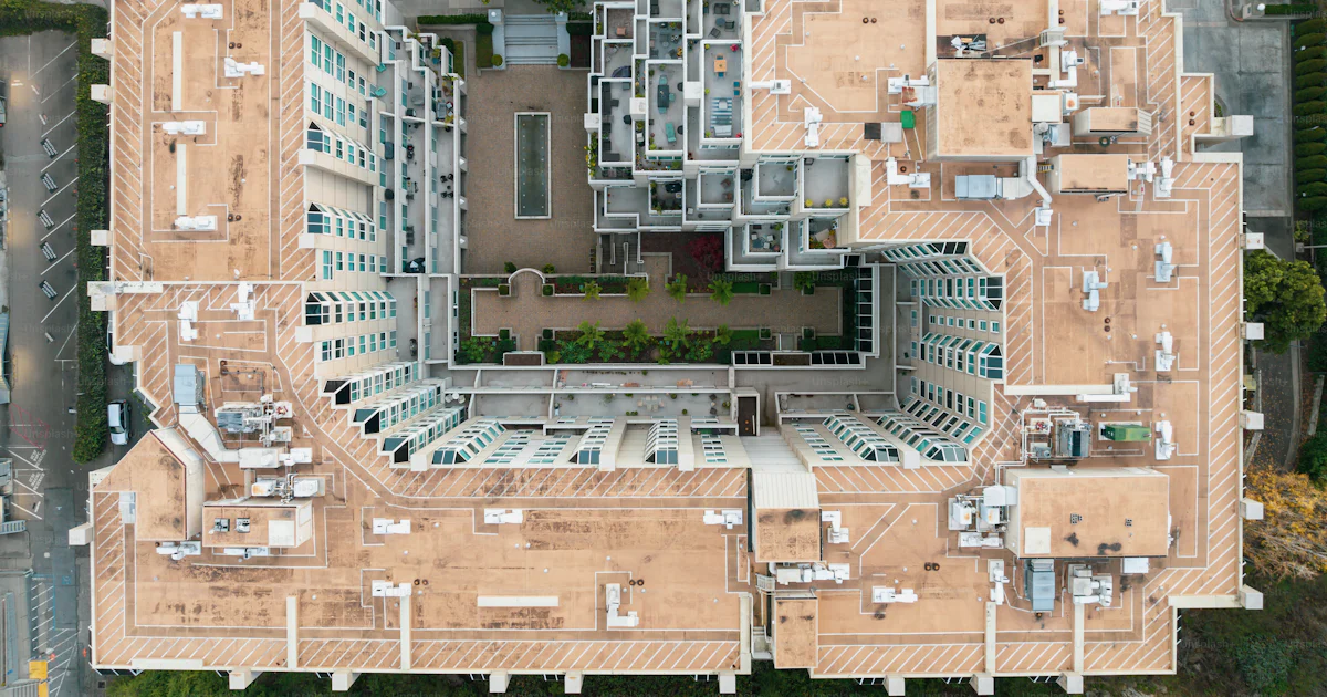 An aerial view of a building with multiple floors photo – Building ...