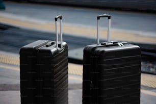 two black suitcases sitting next to each other