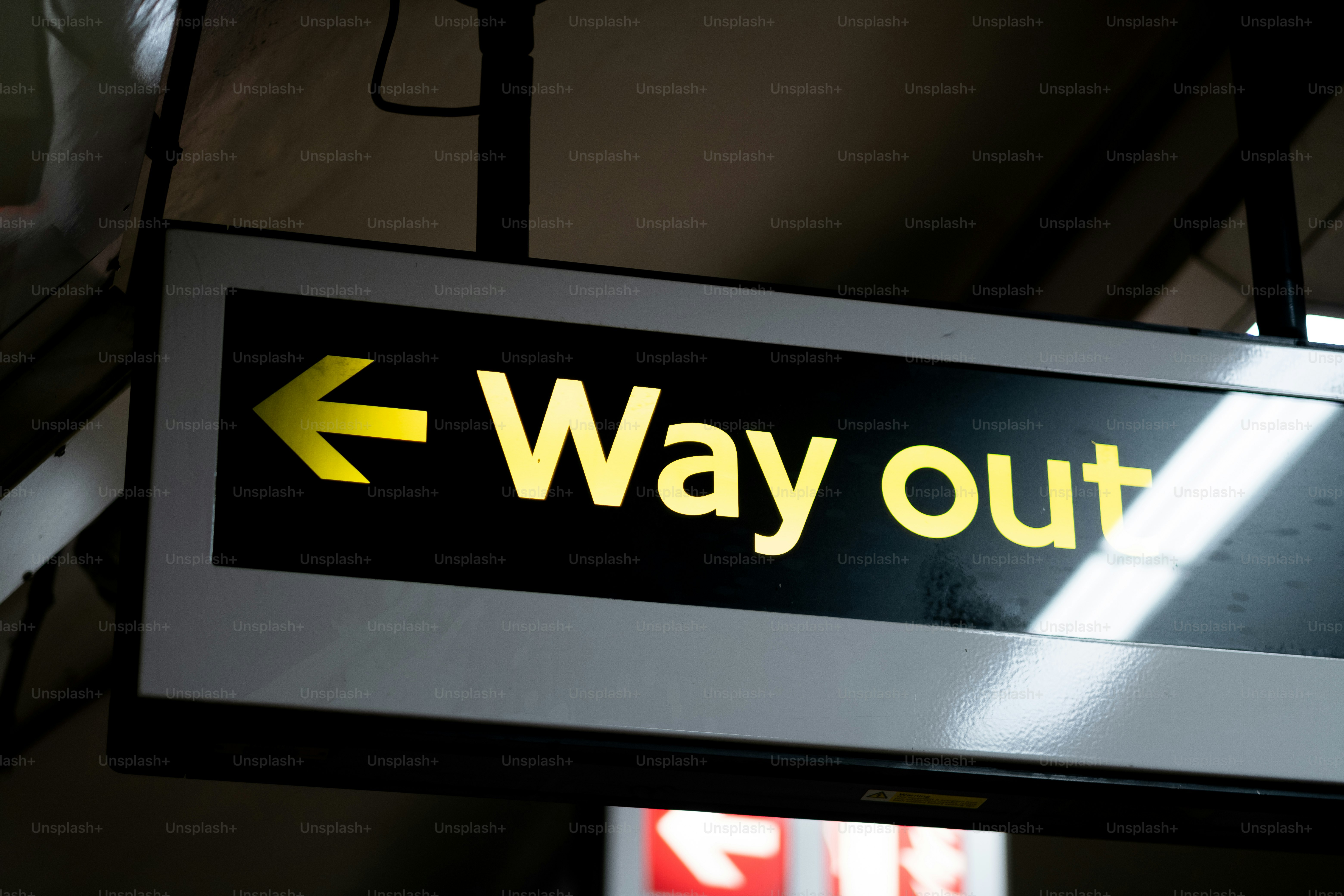 A 'way out' sign in a train station.