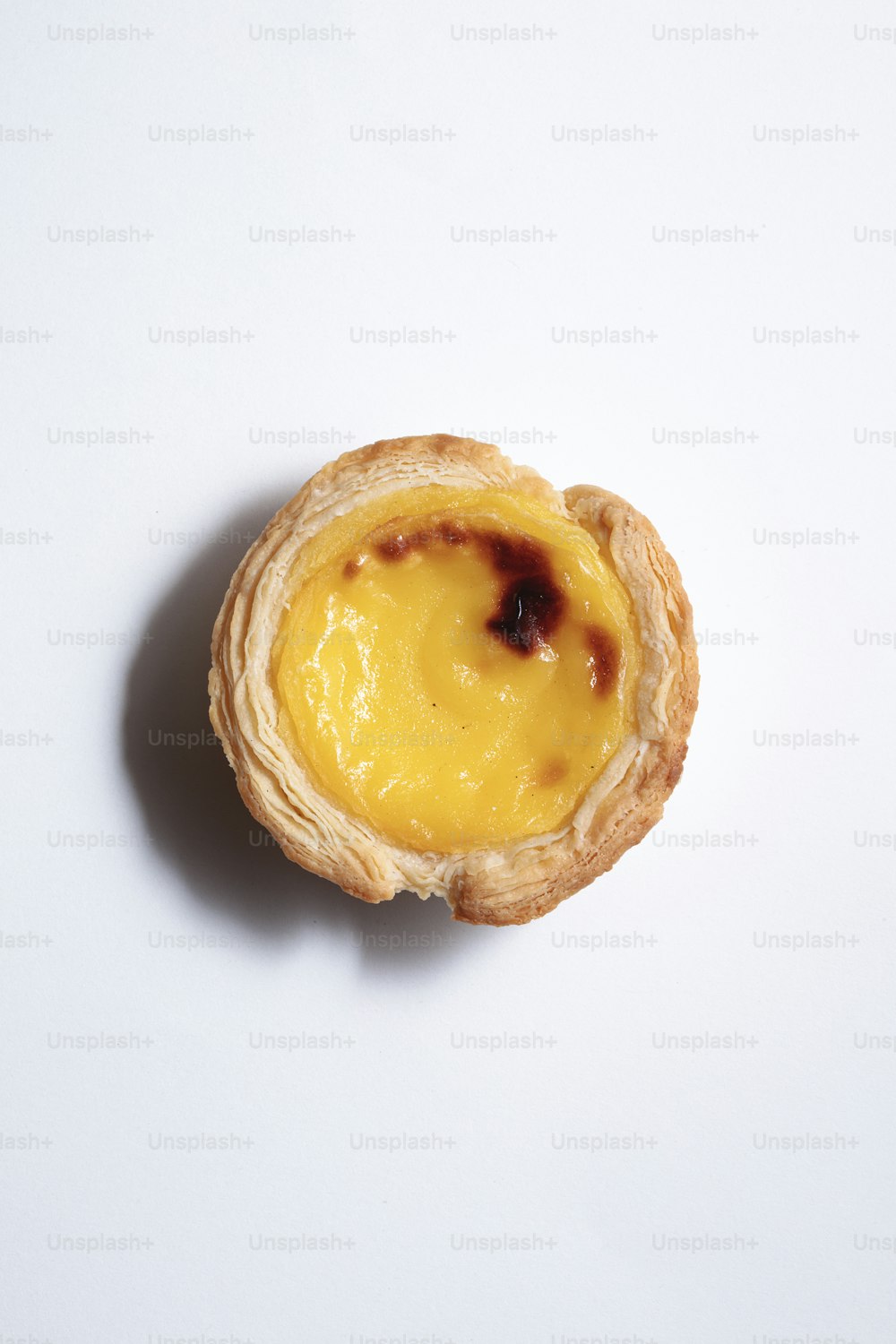 a pastry with a yellow filling on a white surface