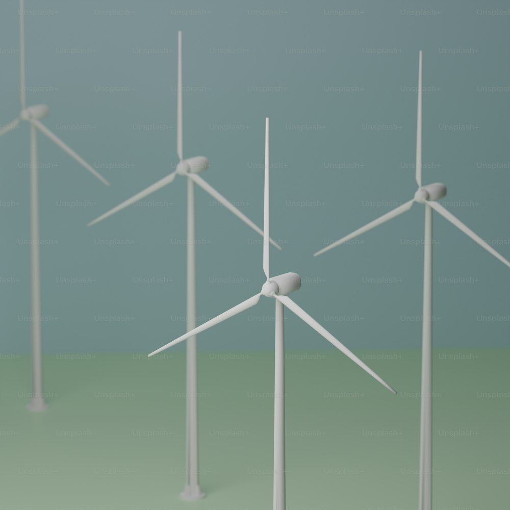 a group of wind turbines on a green surface