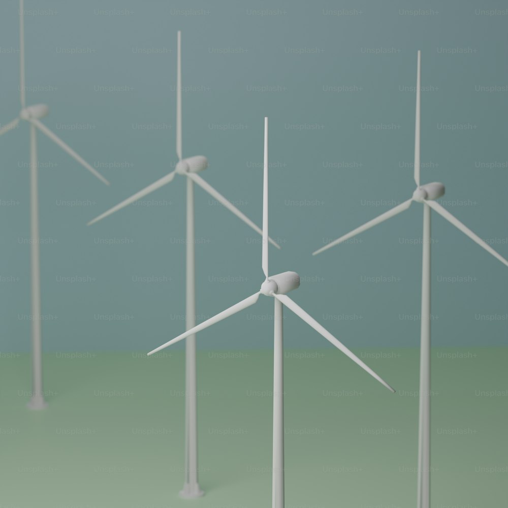 a group of wind turbines on a green surface