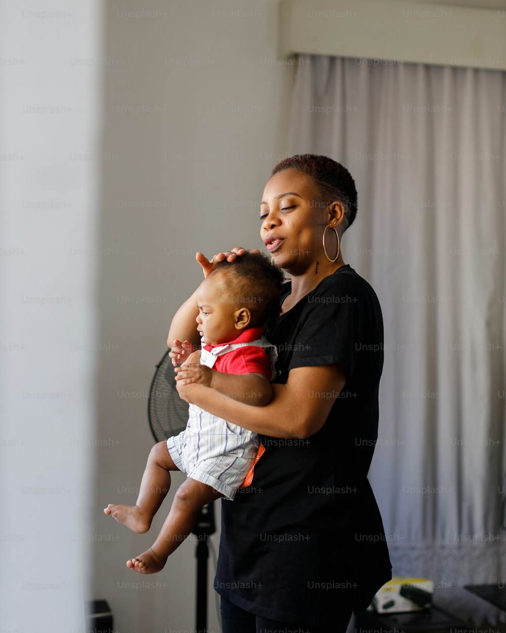 a woman holding a baby in her arms