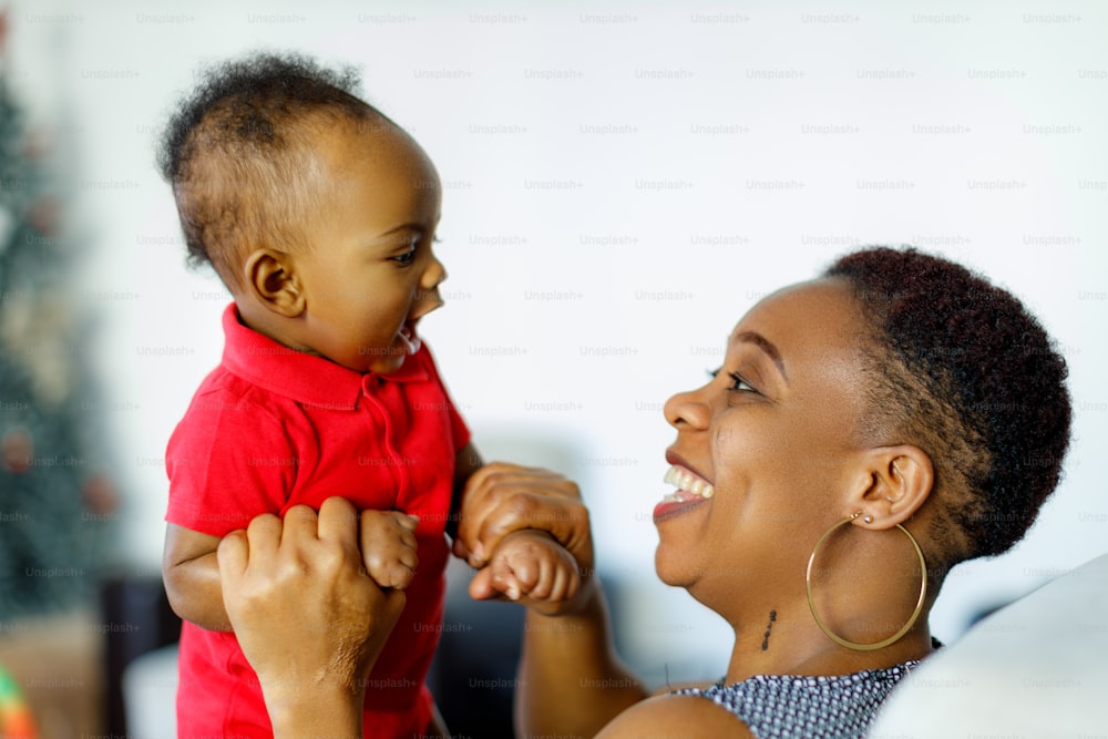 a woman holding a baby up to her face