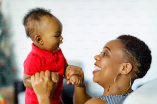 a woman holding a baby up to her face