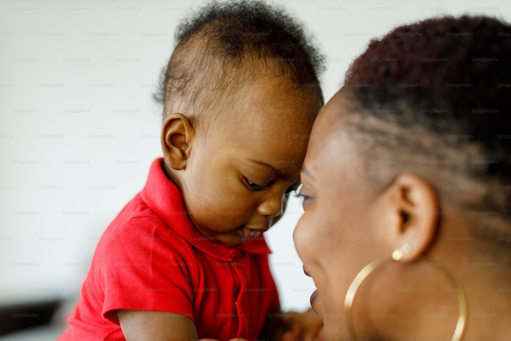 a woman holding a baby in her arms