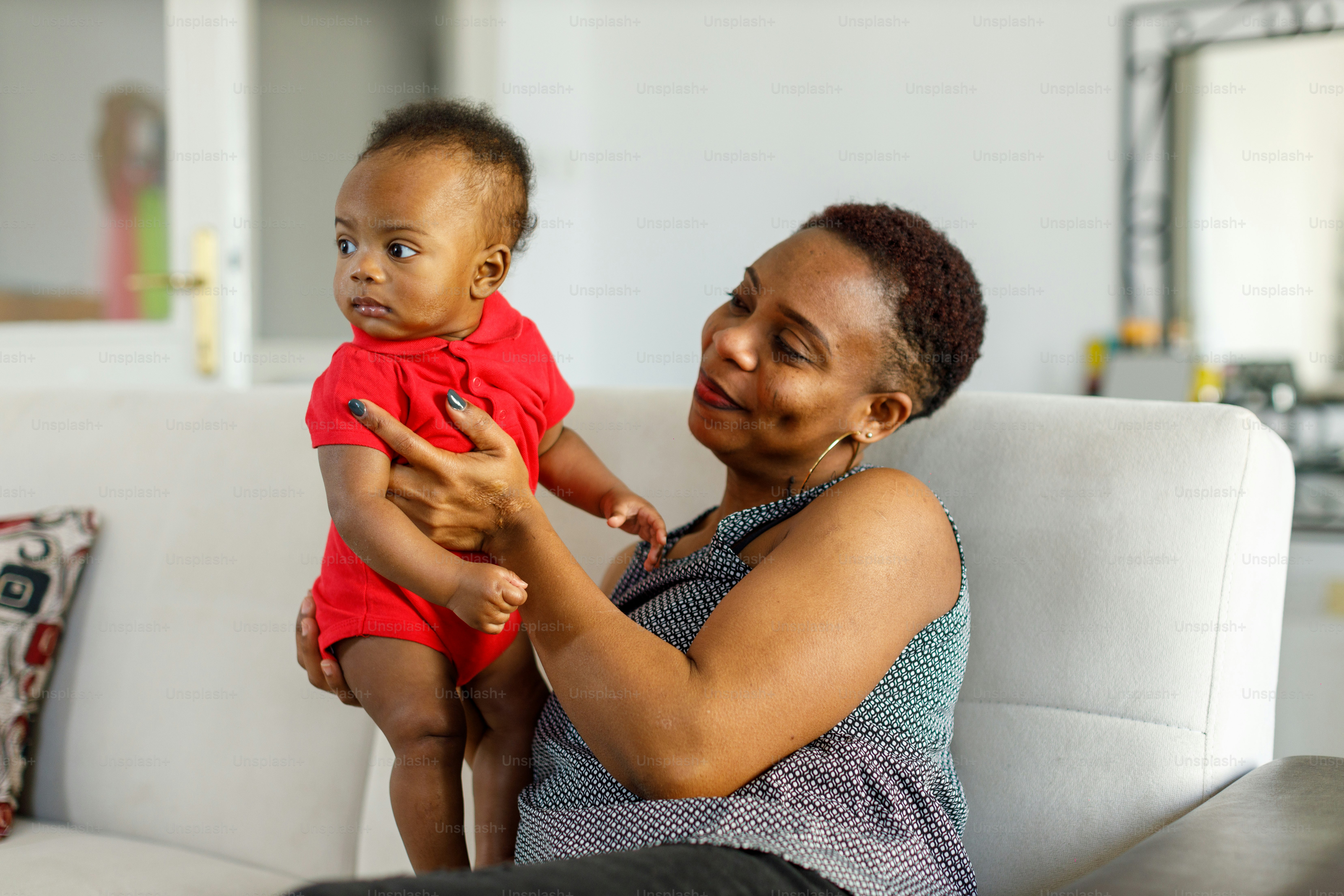 a woman holding a baby on her lap