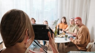 a woman taking a picture of a group of people