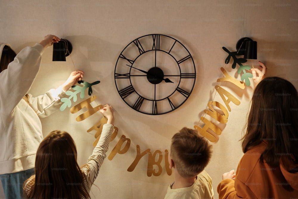 a group of people putting letters on a wall