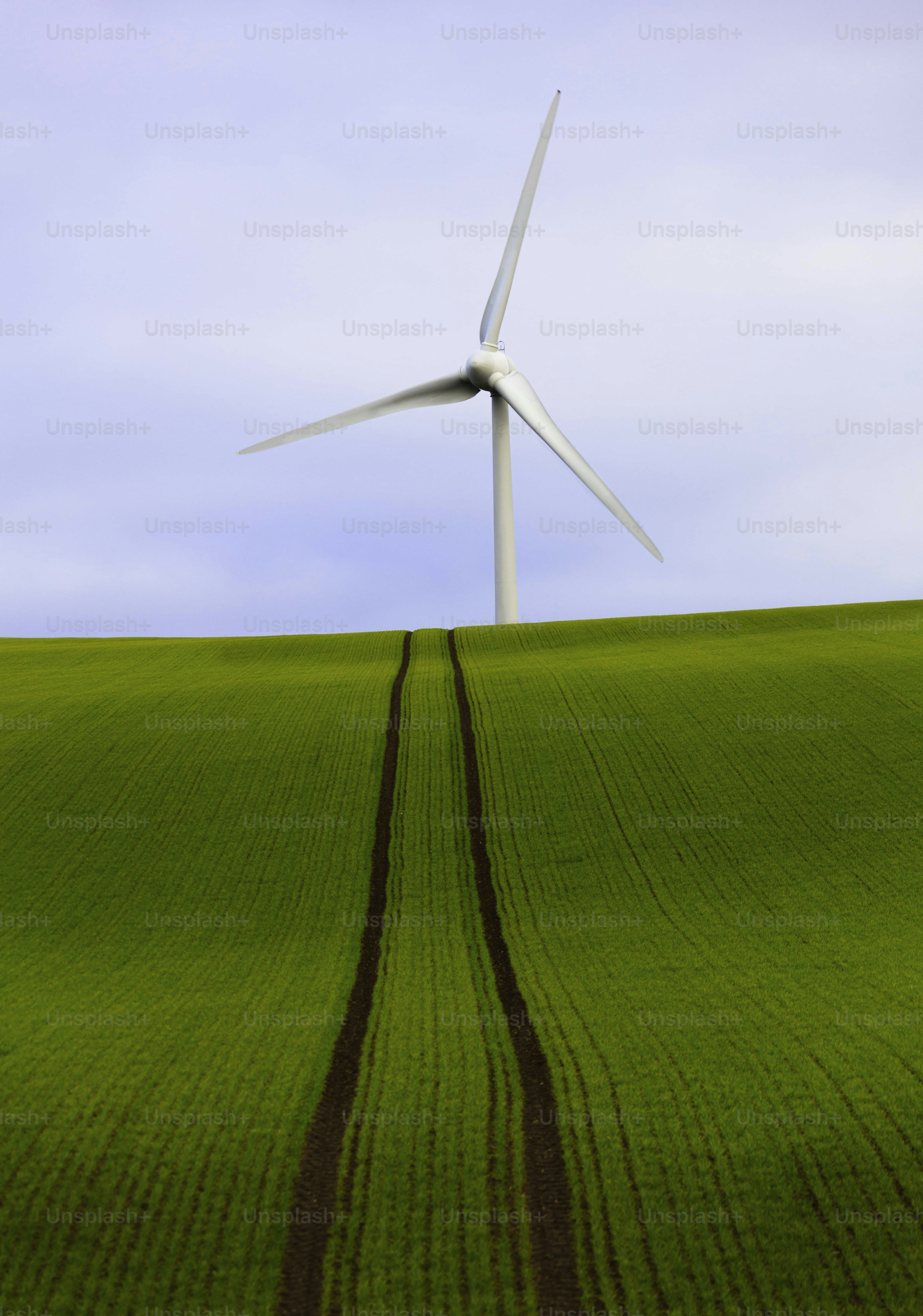 a wind turbine on top of a green field