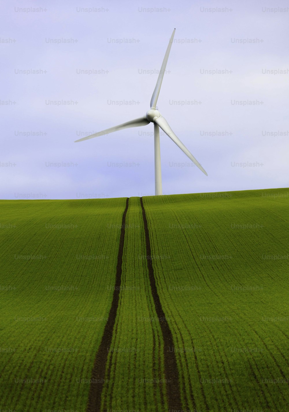 une éolienne au-dessus d’un champ vert