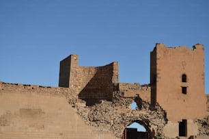 a large brick building with a clock on it's side