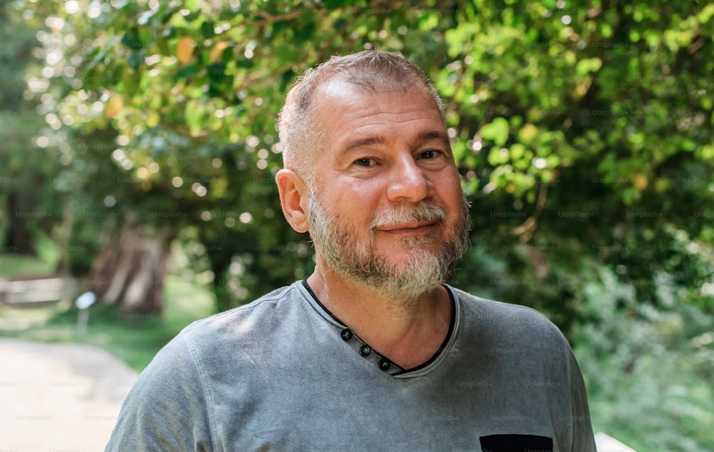 a man standing in front of a tree