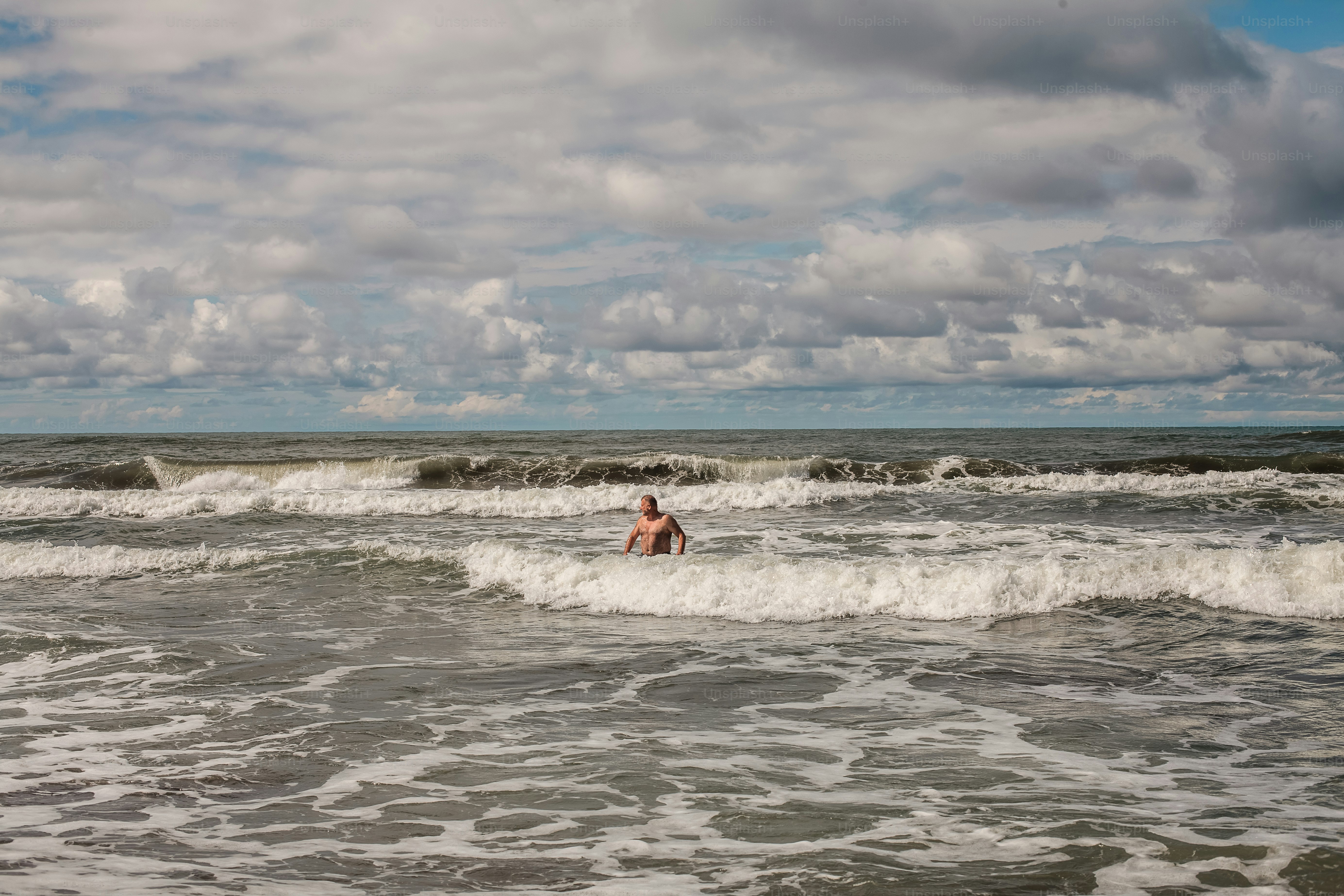 a man riding a wave on top of a surfboard