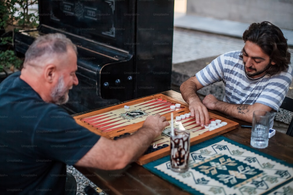 a man playing a game of checkers with another man