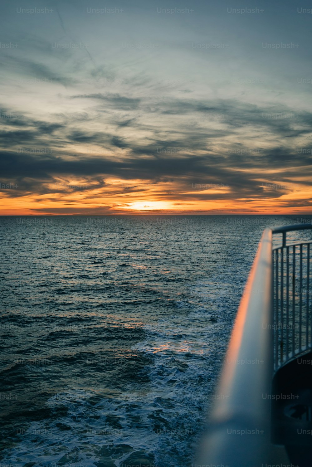 Il sole sta tramontando sull'oceano visto da una barca