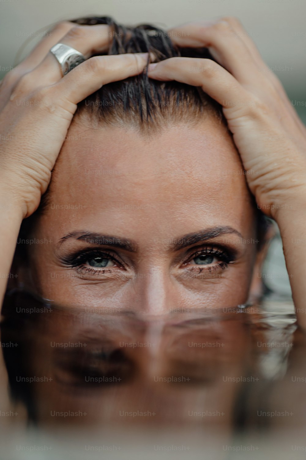 a woman holding her head in the water