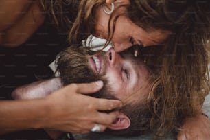 a man getting his hair cut by a woman