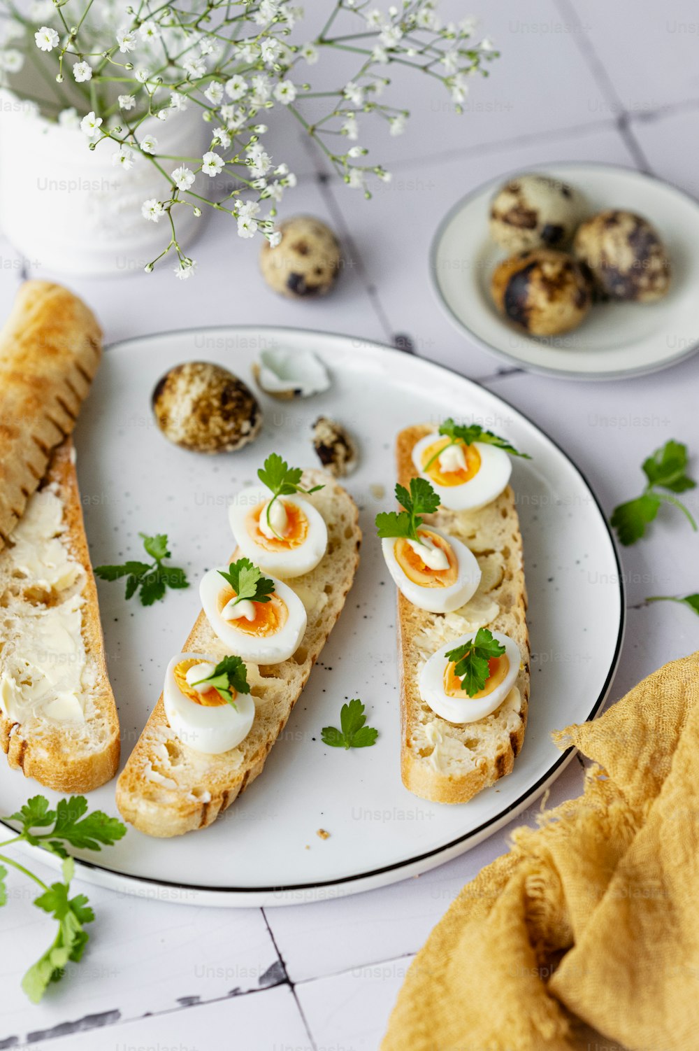 a white plate topped with slices of bread covered in eggs