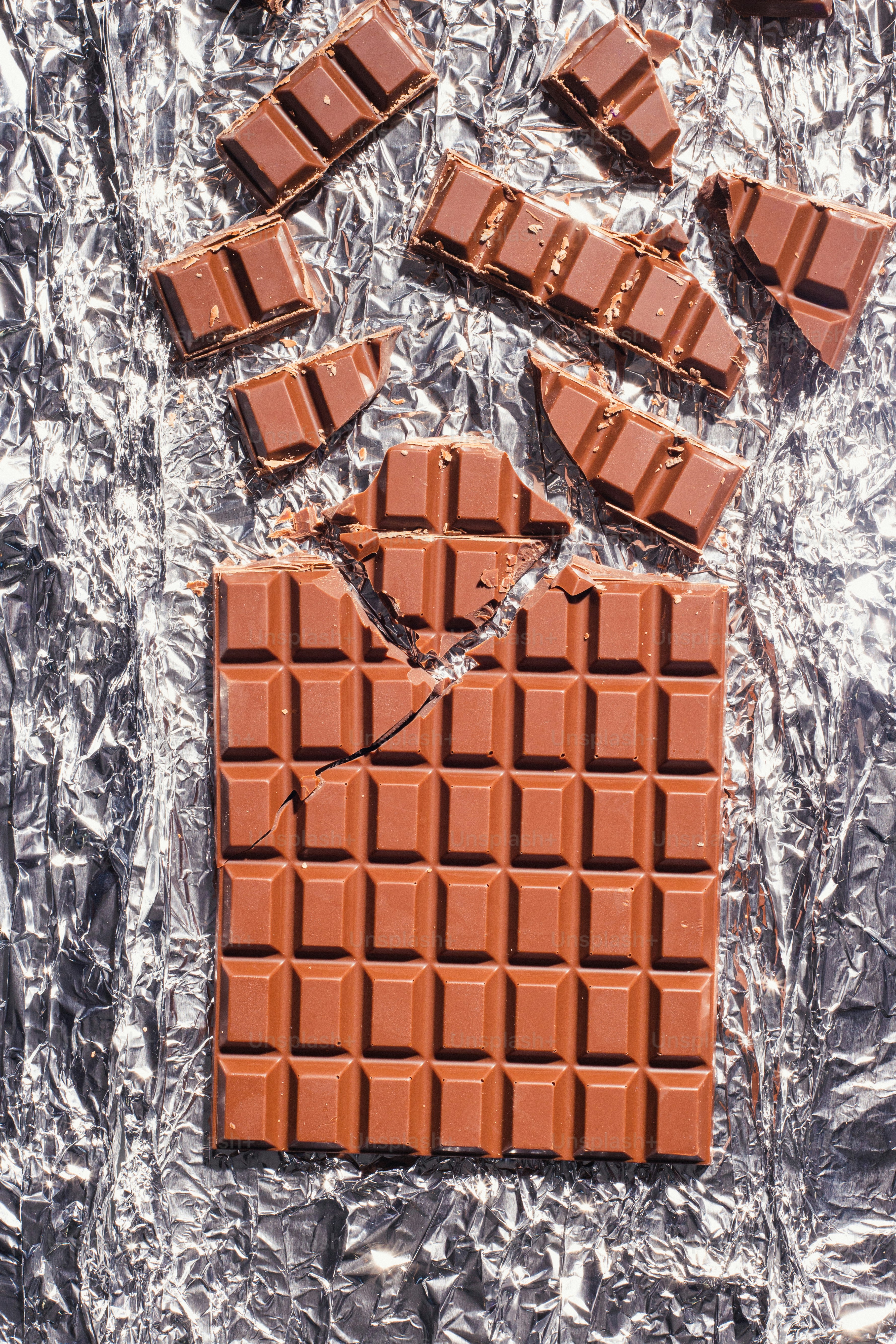 a piece of chocolate is laying on a piece of tin foil