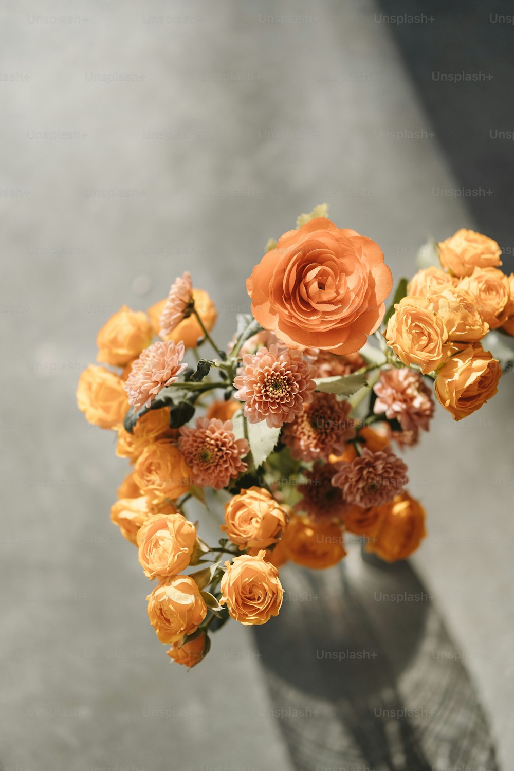 a vase filled with orange flowers on top of a table