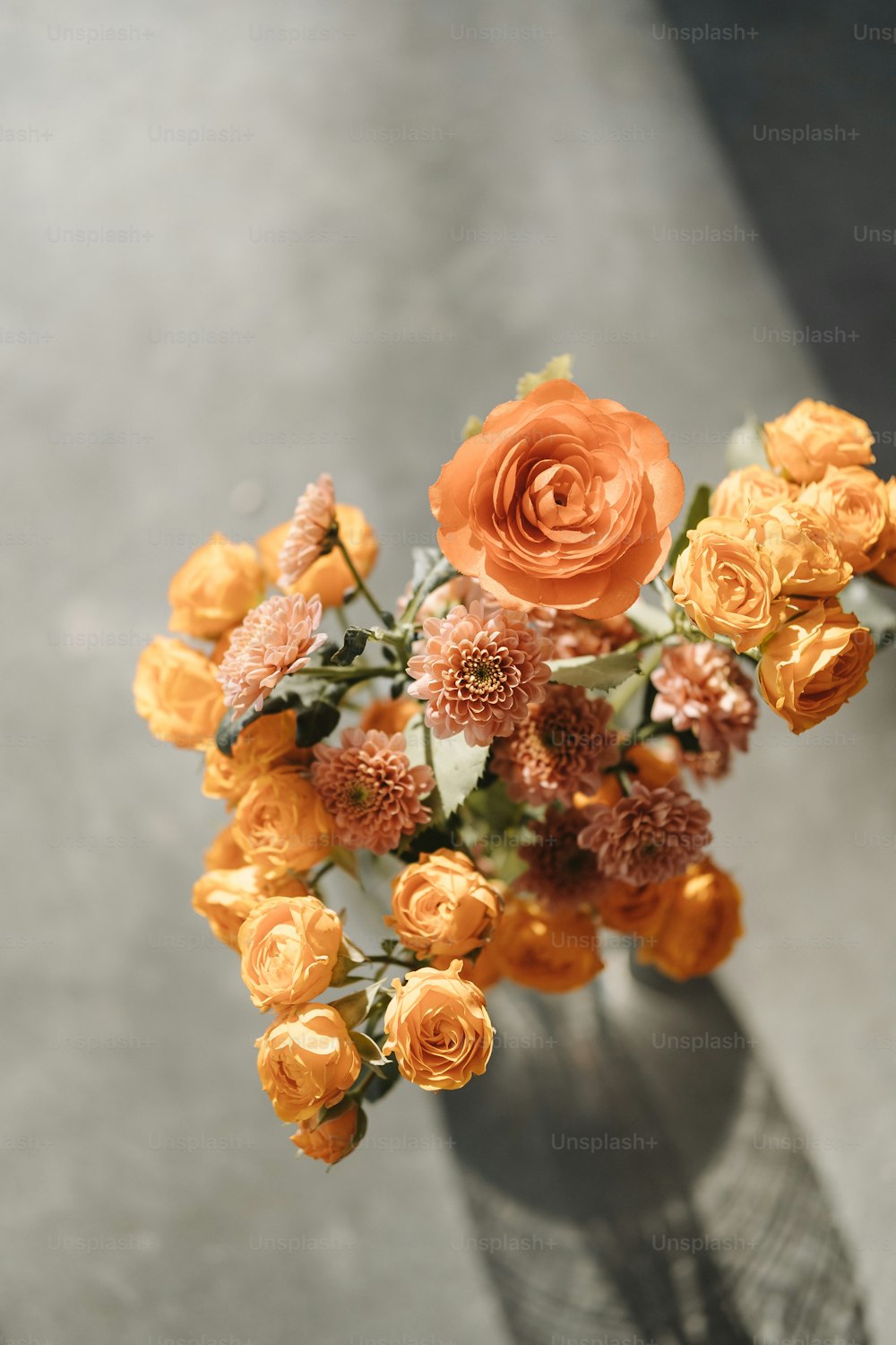 テーブルの上にオレンジ色の花が入った花瓶