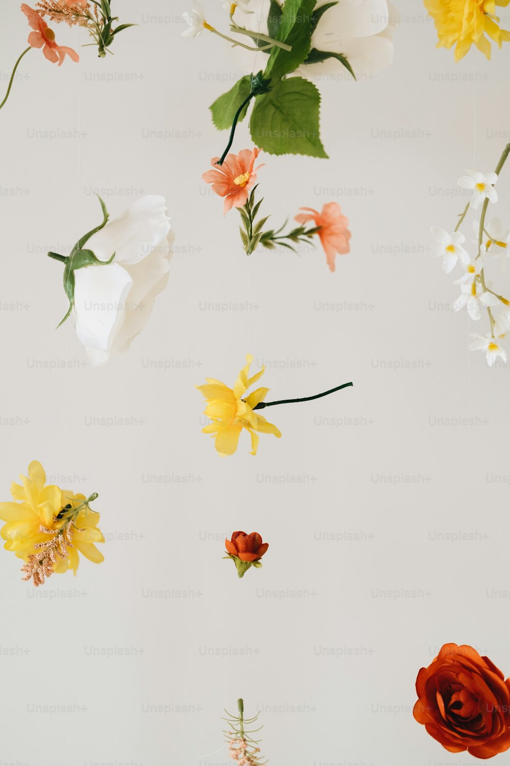 a bunch of flowers hanging from a ceiling