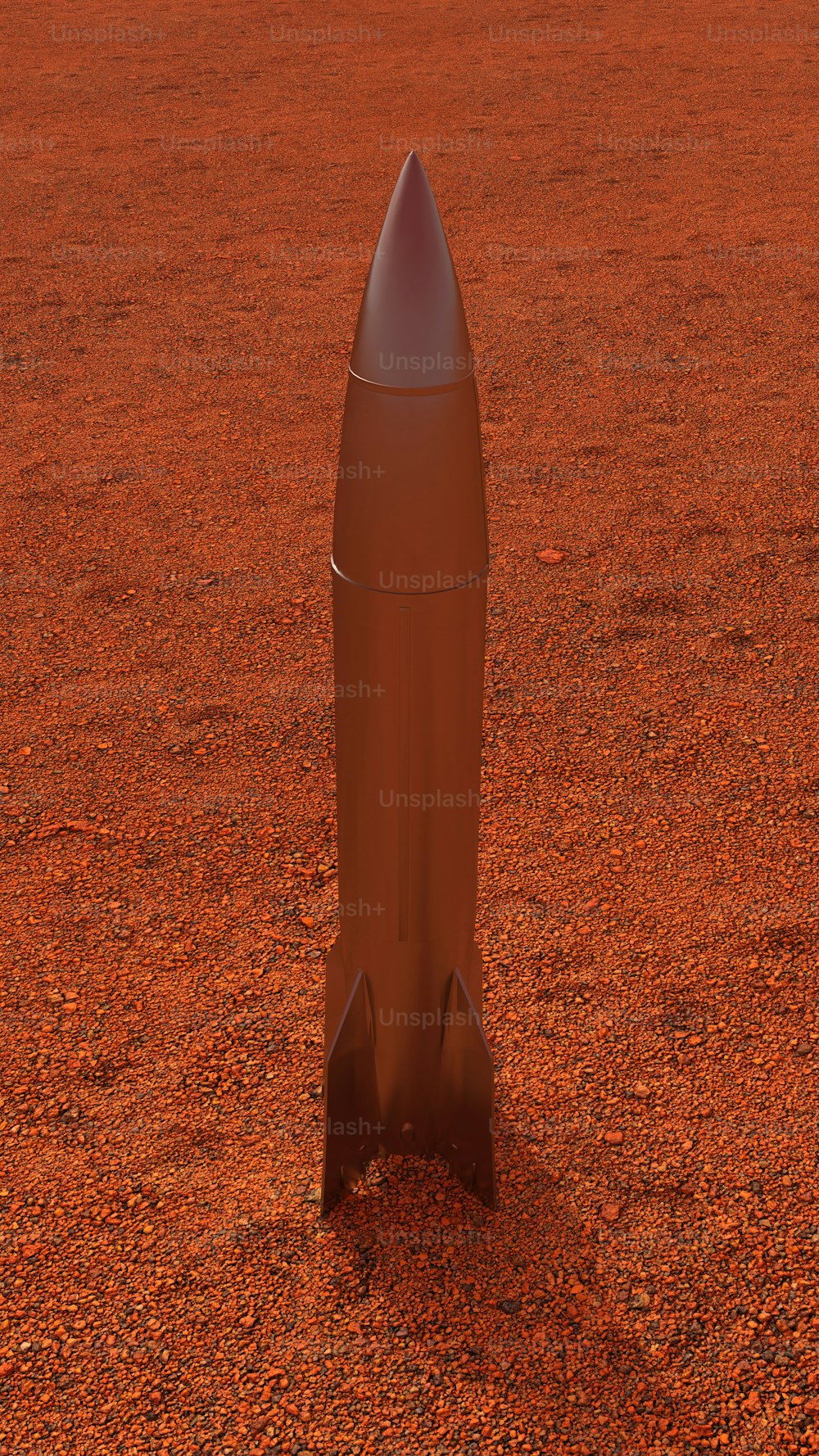 um pequeno foguete sentado em cima de um campo de terra