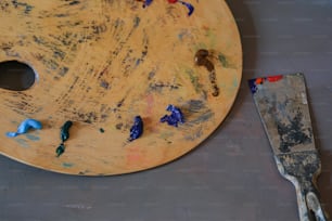 a paint palette and a spatula on a table