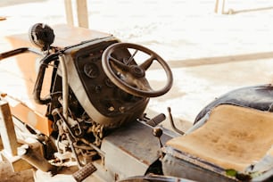 an old car with a steering wheel and a seat
