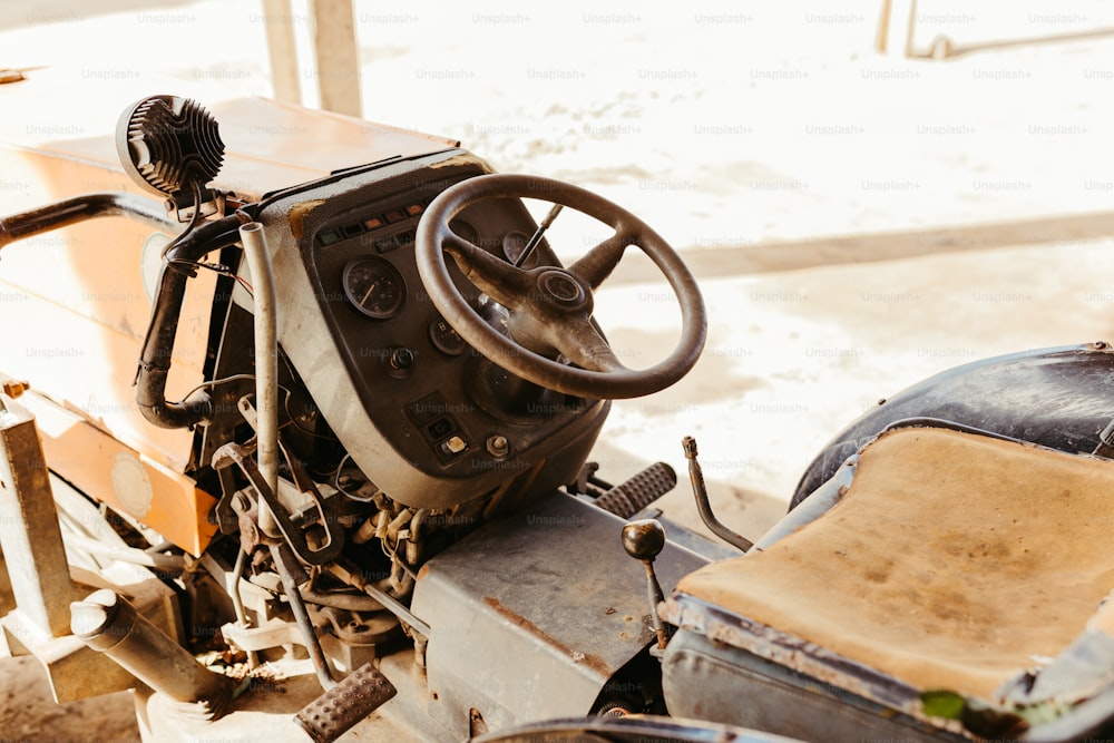 an old car with a steering wheel and a seat