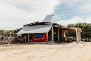 a barn with a tractor parked in front of it