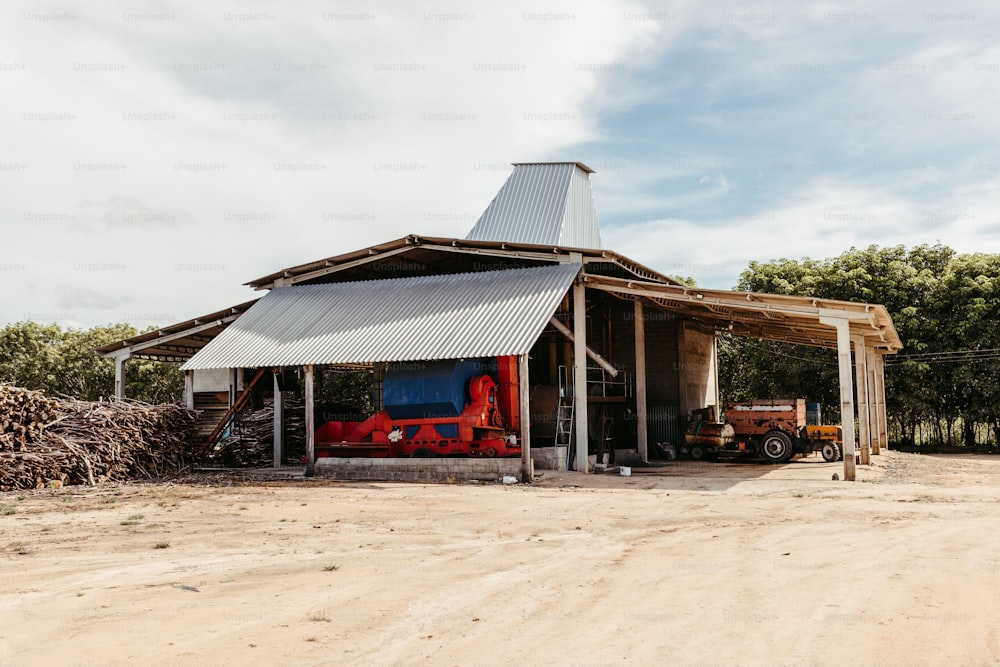 a barn with a tractor parked in front of it