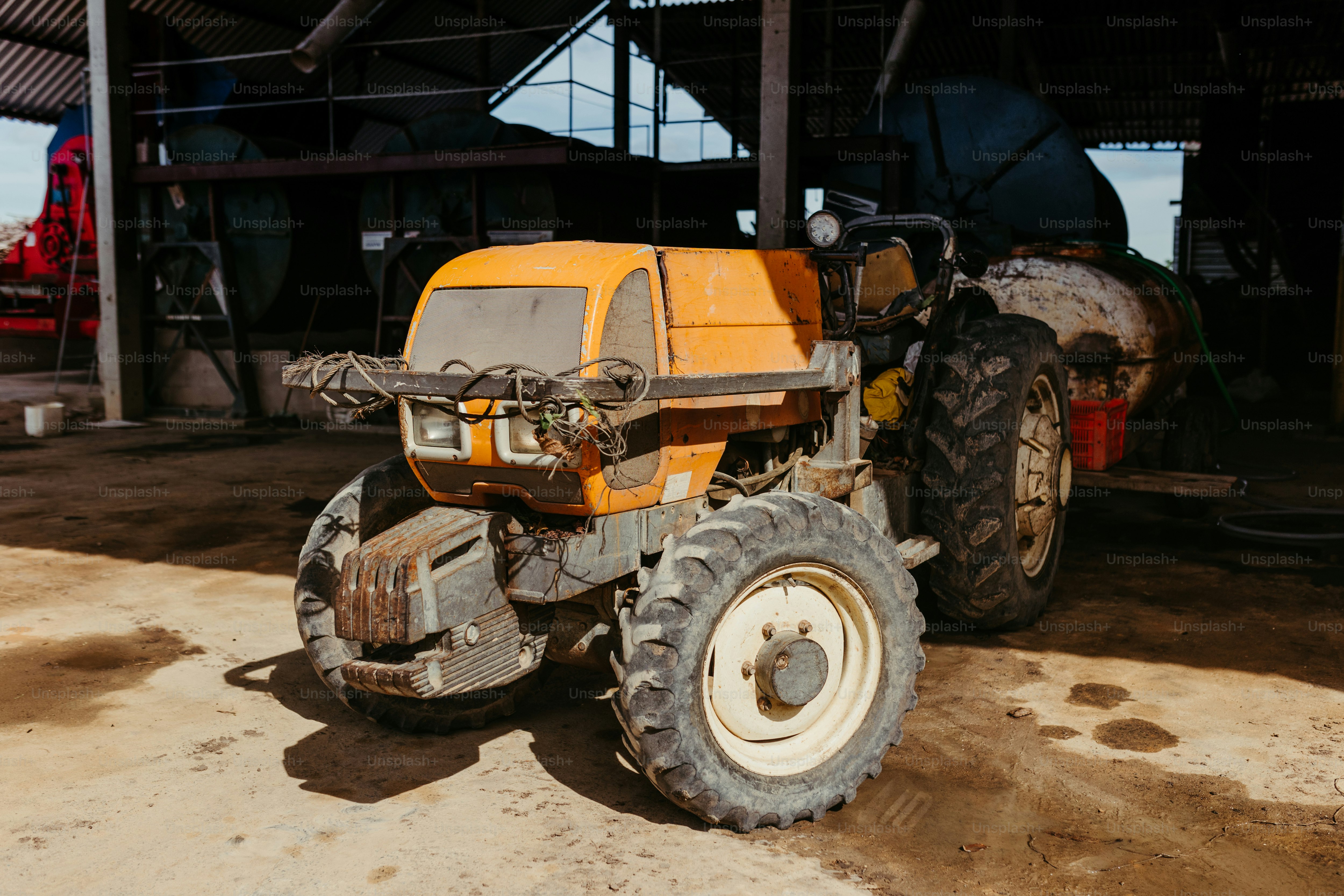 a yellow tractor parked in front of a building
