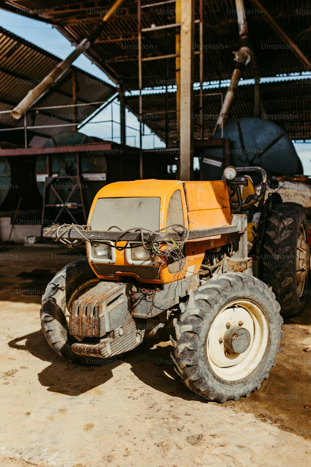 a yellow tractor parked in front of a building
