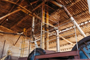 a building with pipes and scaffolding on the roof