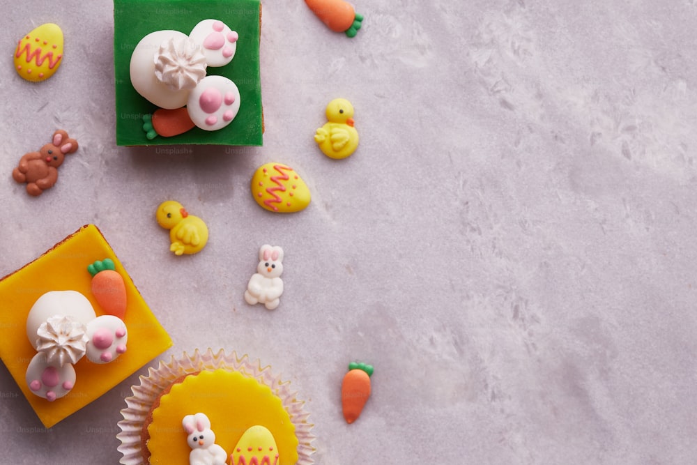 a table topped with cupcakes covered in frosting