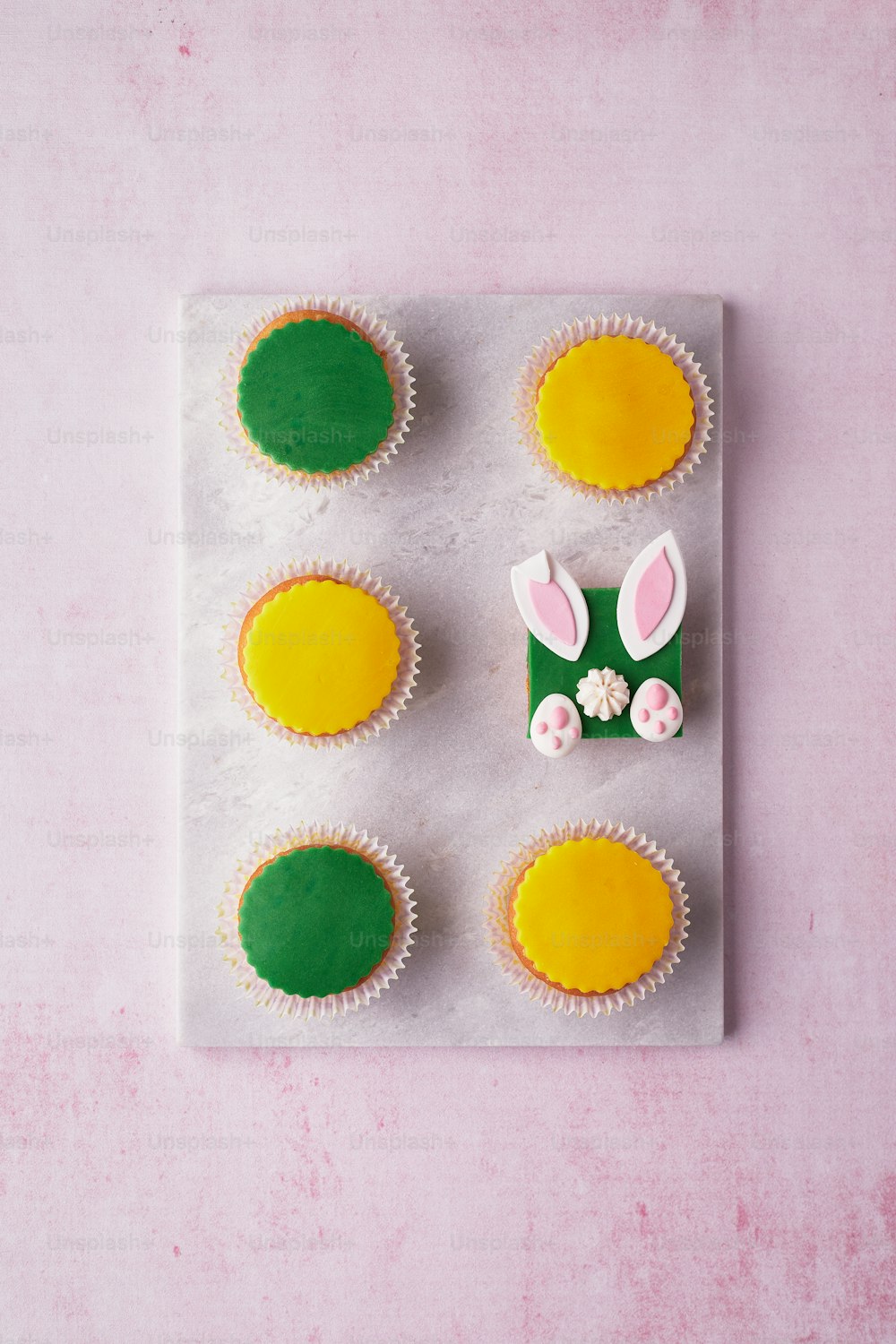 a tray of cupcakes with bunny ears on them
