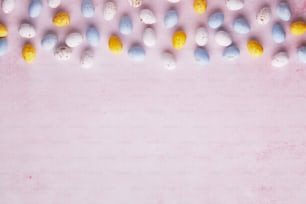 a pink background with a bunch of eggs on it