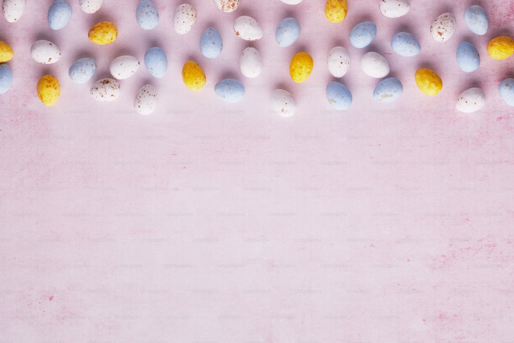 a pink background with a bunch of eggs on it