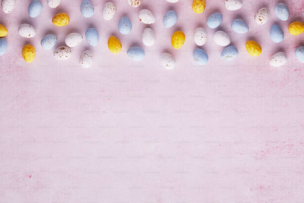 a pink background with a bunch of eggs on it