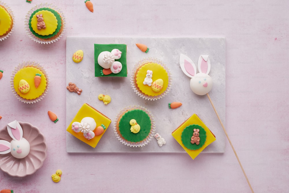 a table topped with cupcakes covered in frosting