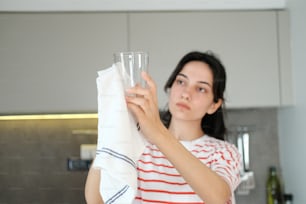 a woman holding a glass in her hand