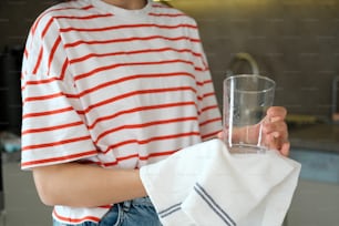 a woman holding a glass of water in her hand