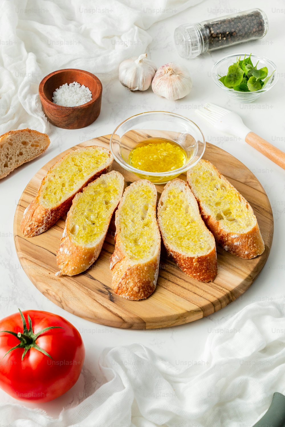 a wooden plate topped with slices of bread and a bowl of mustard
