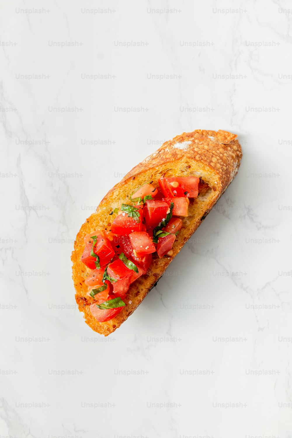 a piece of bread with tomatoes on top of it