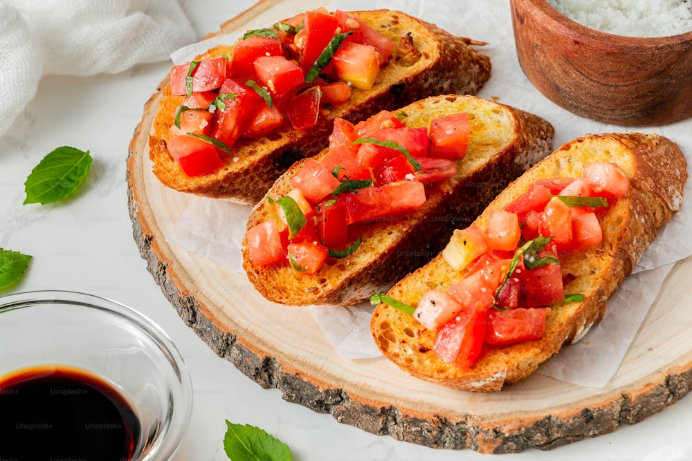toasted bread with tomatoes and basil on a plate
